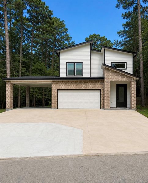 Front exterior of a new home in , Coldspring, TX, highlighting curb appeal (Image 2). Front exterior of a new home in , Coldspring, TX, highlighting curb appeal (Image 2).