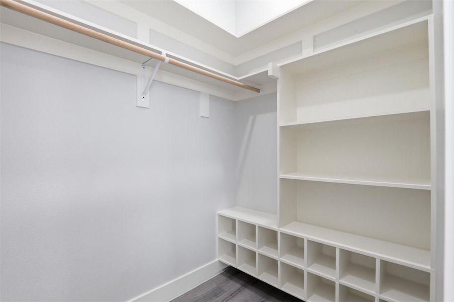 Custom closet system featuring built-in shelving, cubbies, and a hanging rod