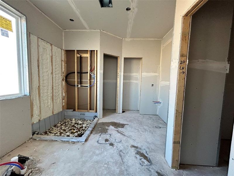 A modern main bathroom featuring sleek finishes, a spacious shower, and a relaxing soaking tub for the perfect retreat.