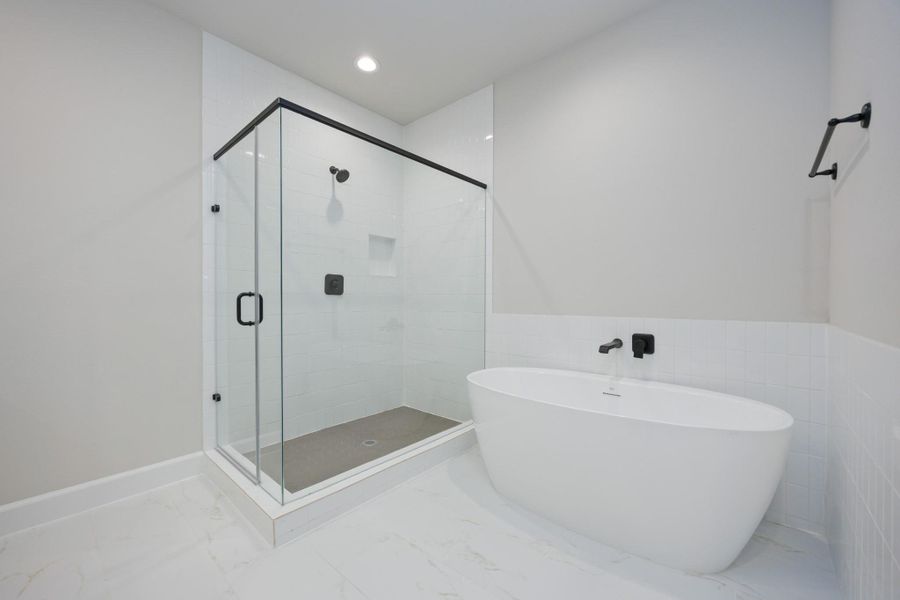 Soak away the stress of the day in your freestanding tub while your favorite playlist echoes off spa-white walls. This luxury en suite was made for unwinding. Soak away the stress of the day in your freestanding tub while your favorite playlist echoes off spa-white walls. This luxury en suite was made for unwinding.