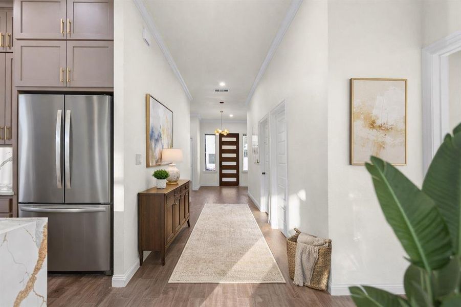 Hallway connecting foyer to the open concept living room (staged) Hallway connecting foyer to the open concept living room (staged)