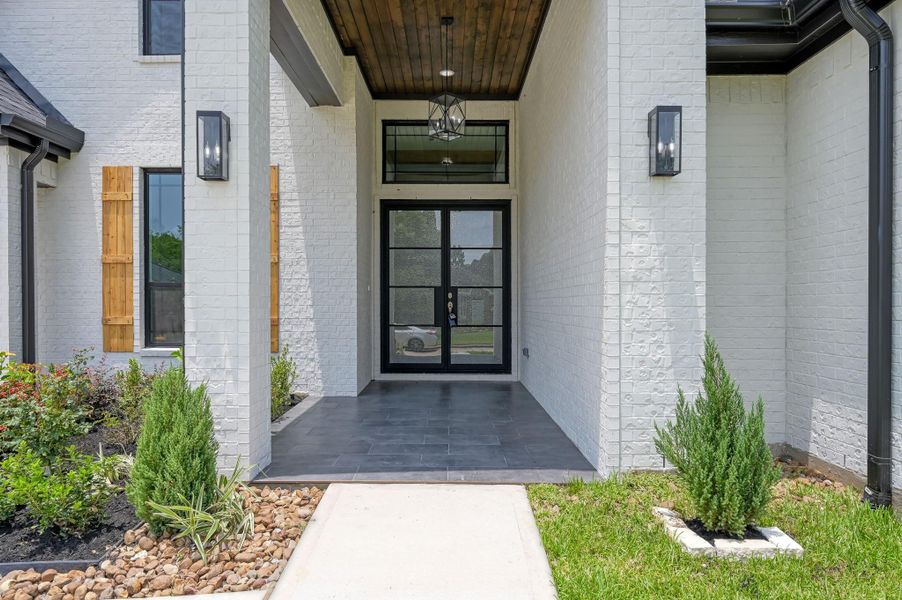 Double iron and glass front doors set the tone for the refined interior that awaits. Double iron and glass front doors set the tone for the refined interior that awaits.
