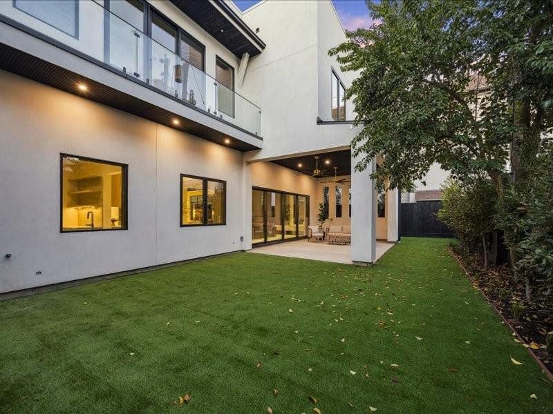 A fully turfed yard ensures vibrant, maintenance-free greenery in every season, complemented by beautiful trees that create a serene, natural backdrop.