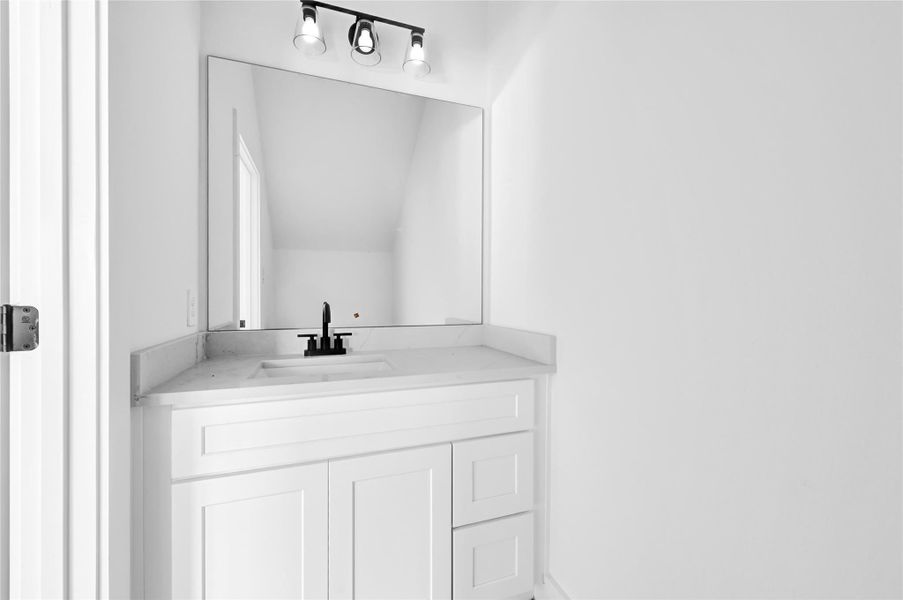 Convenient half bath on the main floor with modern fixtures. Convenient half bath on the main floor with modern fixtures.