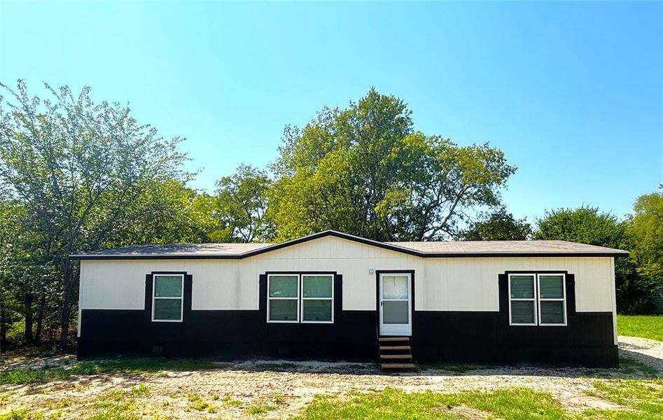 Front exterior of a new home in , Quinlan, TX, highlighting curb appeal (Image 23).