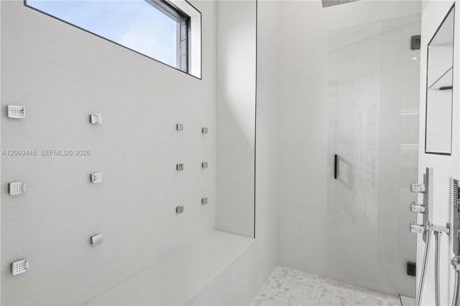 Oversized dual walk-in showers w/ rainfall fixtures, handheld sprayers, body sprays & designer finishes throughout Oversized dual walk-in showers w/ rainfall fixtures, handheld sprayers, body sprays & designer finishes throughout