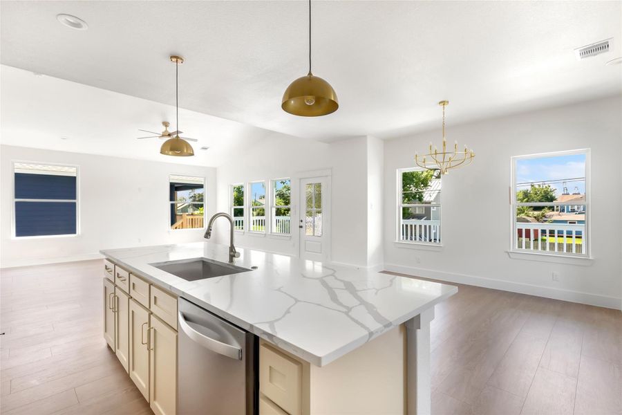 Experience the style and functionality in this bright, open-concept kitchen, dining, and living area, perfect for modern living and entertaining.
