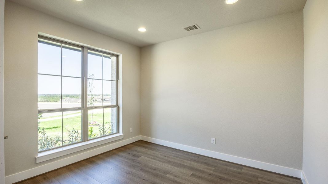 Unfurnished room with recessed lighting and dark wood-style floors Unfurnished room with recessed lighting and dark wood-style floors
