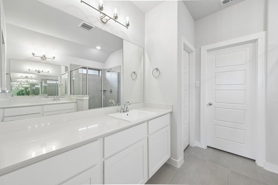 Primary Bathroom in the Heisman home plan by Trophy Signature Homes Primary Bathroom in the Heisman home plan by Trophy Signature Homes