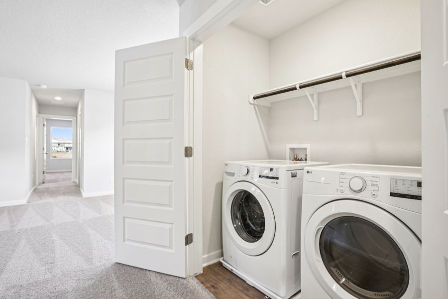 A room with a washing machine and a dryer.