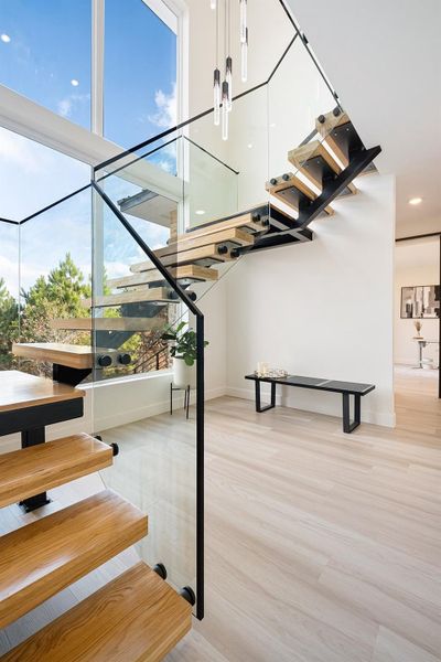 Stairway featuring wood finished floors and baseboards