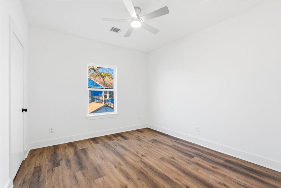 Bedroom number two complete with luxury vinyl flooring and a ceiling fan. No carpet anywhere in this house!