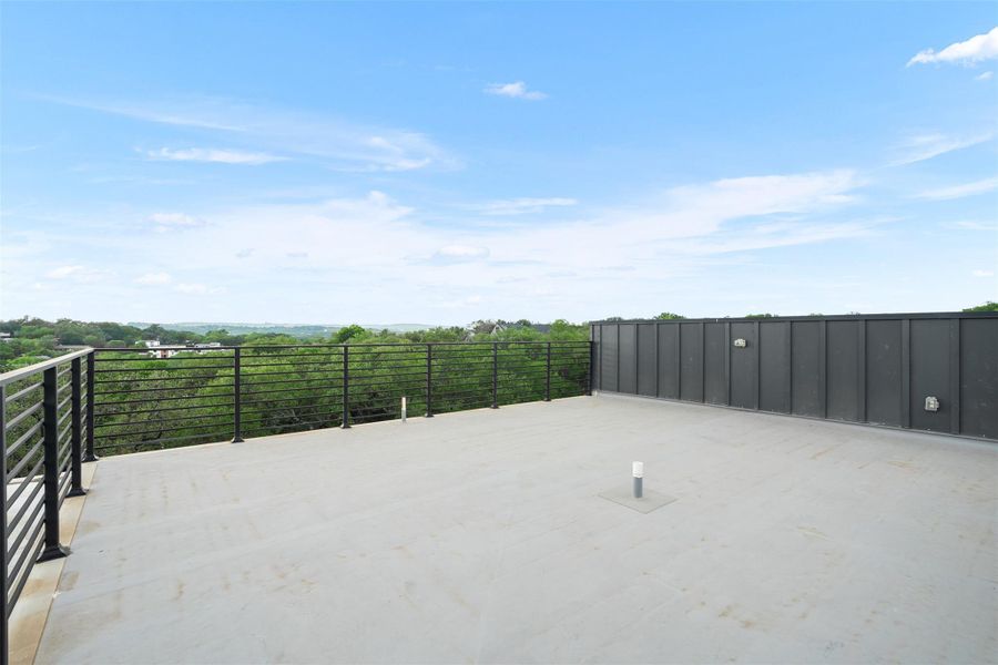 Spacious rooftop terrace with expansive views of the surrounding green landscape