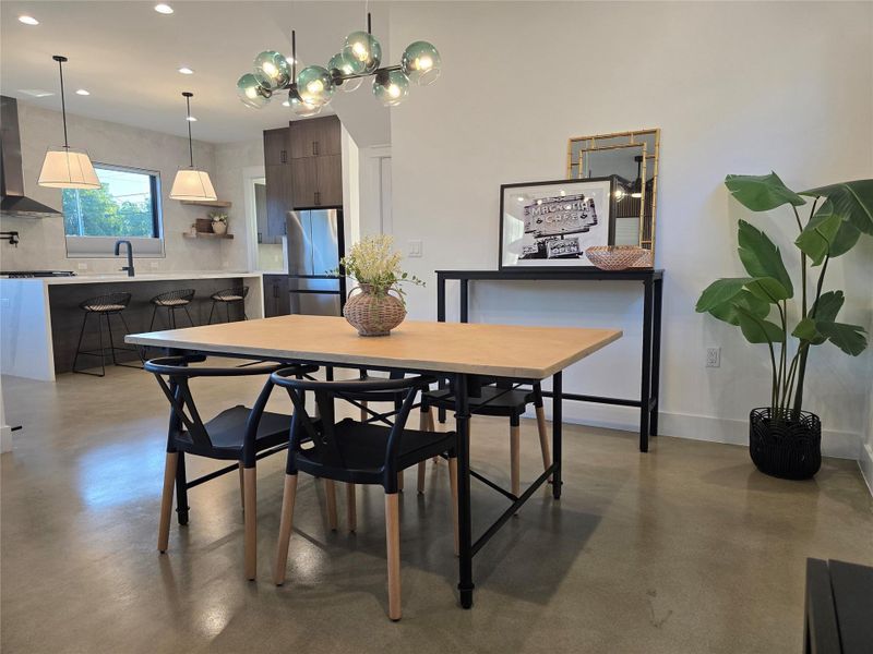 Polished concrete floors and high ceilings frame this contemporary dining space.