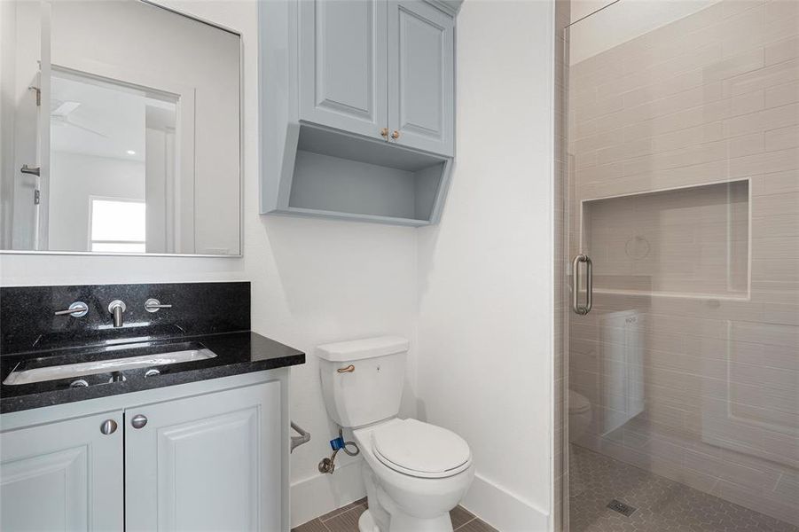 Full bathroom featuring a stall shower and vanity Full bathroom featuring a stall shower and vanity