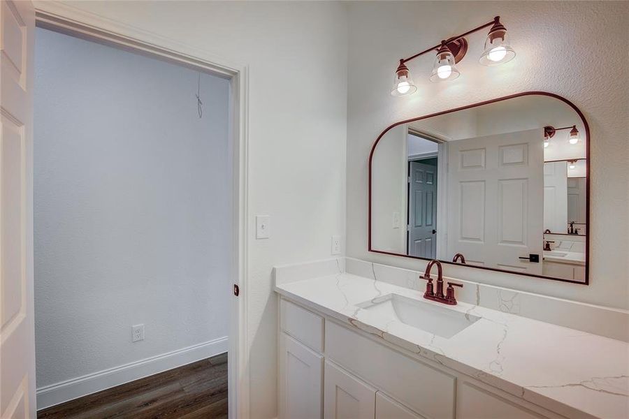 Bathroom with vanity and wood finished floors Bathroom with vanity and wood finished floors