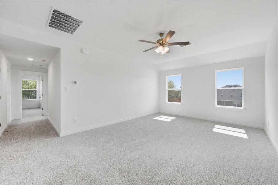 Spare room with light carpet, healthy amount of natural light, and ceiling fan Spare room with light carpet, healthy amount of natural light, and ceiling fan