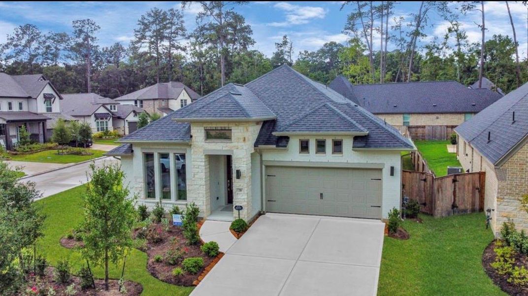 Front exterior of a new home in Woodforest, Montgomery, TX, highlighting curb appeal (Image 21).