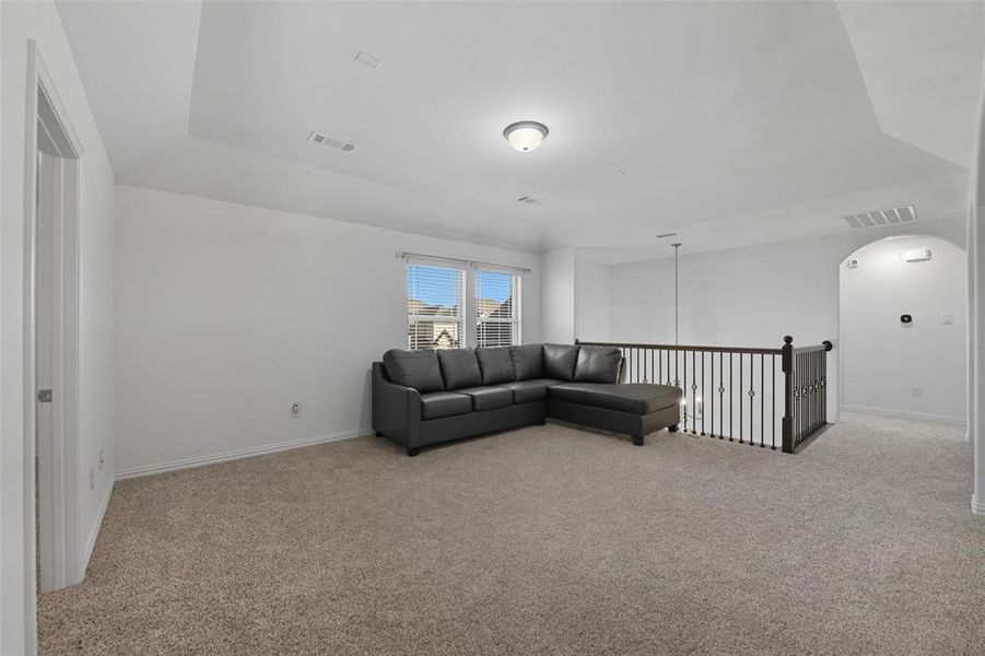 2nd floor Living room with light carpet and arched walkways 2nd floor Living room with light carpet and arched walkways