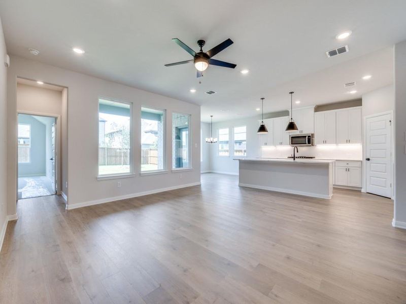 The open concept main floor features beautiful flooring, walls of windows, a dream kitchen and so much more!