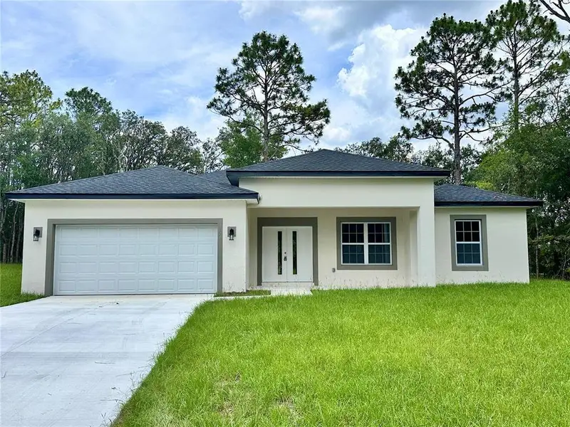 Front exterior of a new home in , Citrus Springs, FL, highlighting curb appeal (Image 15).