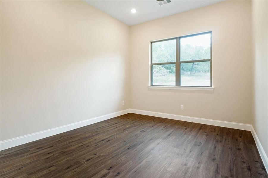 Unfurnished room with dark hardwood / wood-style floors