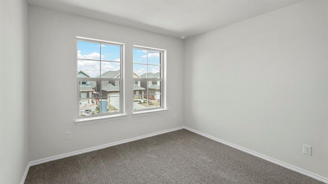 This room features two windows and light-colored walls