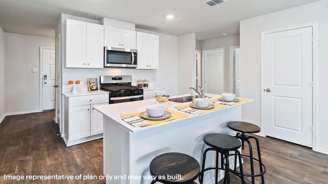 A contemporary kitchen designed for everyday living features an inviting island and essential appliances. A contemporary kitchen designed for everyday living features an inviting island and essential appliances.
