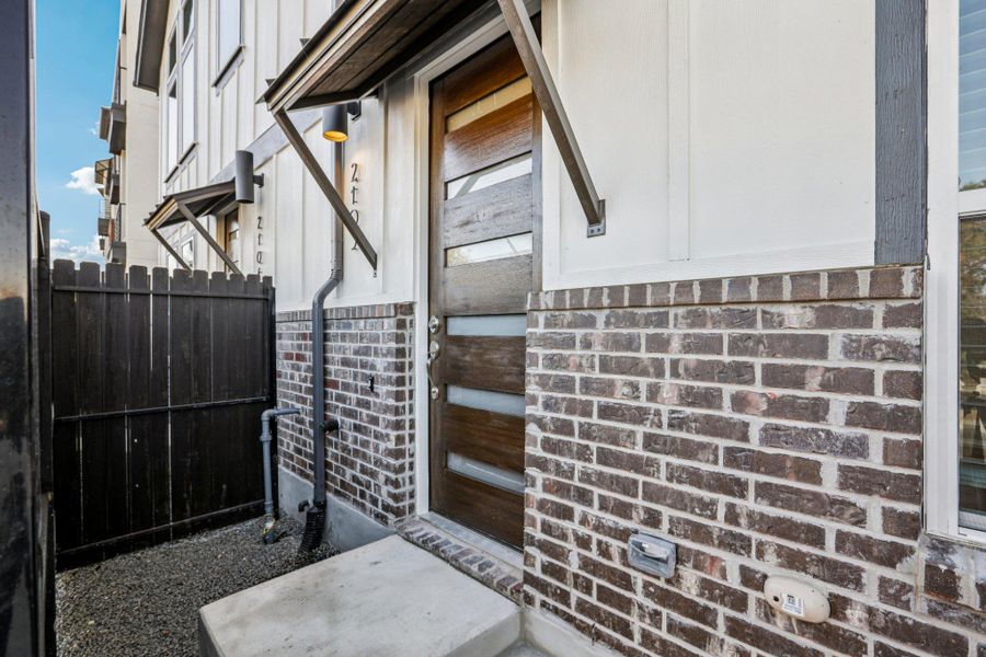 Exterior details and patio area of a home in Koenig Townhomes, Austin (Image 4).