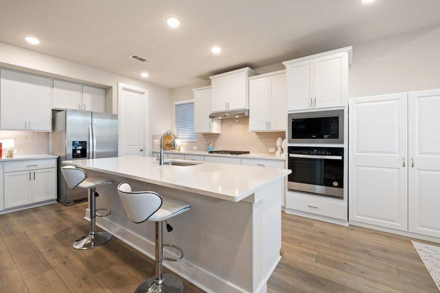 Bright, modern kitchen with generous prep and gathering space.
