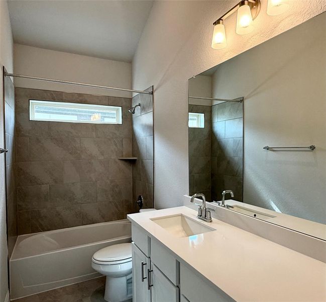 Full bath featuring vanity, shower / washtub combination, and tile patterned floors Full bath featuring vanity, shower / washtub combination, and tile patterned floors