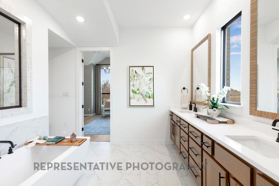 Full bath with marble finish floor, recessed lighting, a sink, and a garden tub
