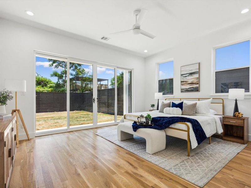 Bedroom with light hardwood / wood-style flooring, access to outside, and ceiling fan