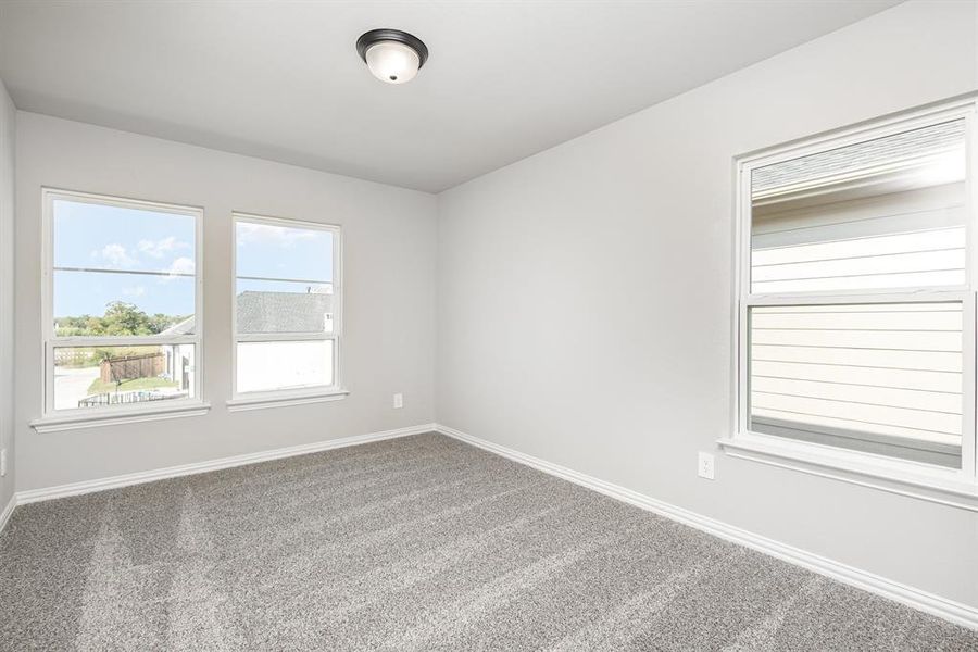 Unfurnished room with carpet and plenty of natural light
