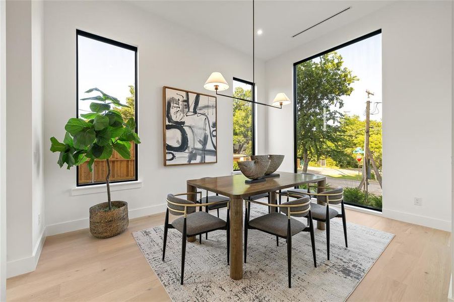 Light wood-finish flooring complements white walls in this dining area Light wood-finish flooring complements white walls in this dining area