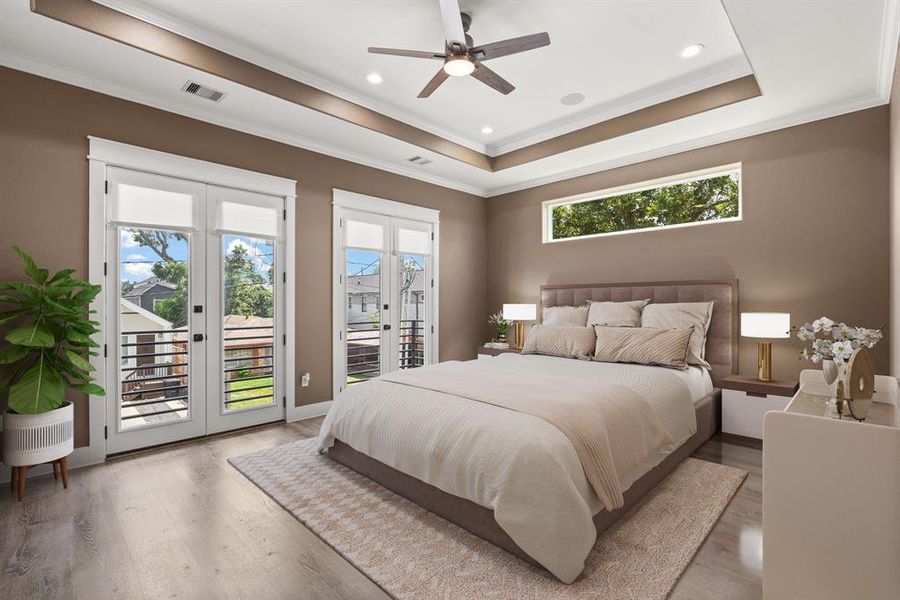 The primary bedroom features double doors leading to a private balcony and boasts vaulted ceilings, creating an airy and luxurious retreat. *Virtually Staged*