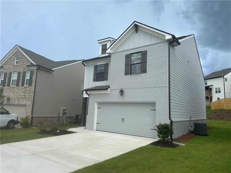 Front exterior of a new home in Kentmere, Auburn, GA, highlighting curb appeal (Image 23). Front exterior of a new home in Kentmere, Auburn, GA, highlighting curb appeal (Image 23).