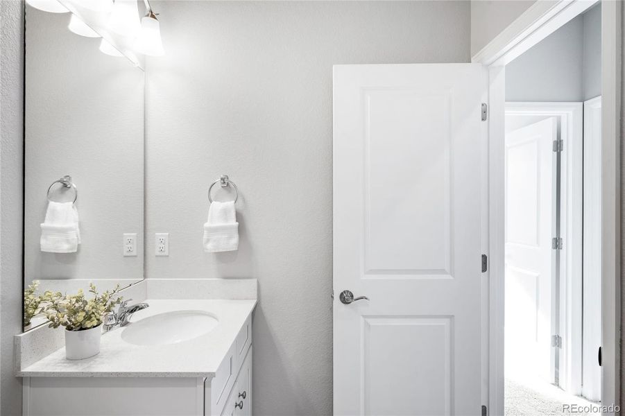 A second, full bathroom on the upper level services the two secondary bathrooms