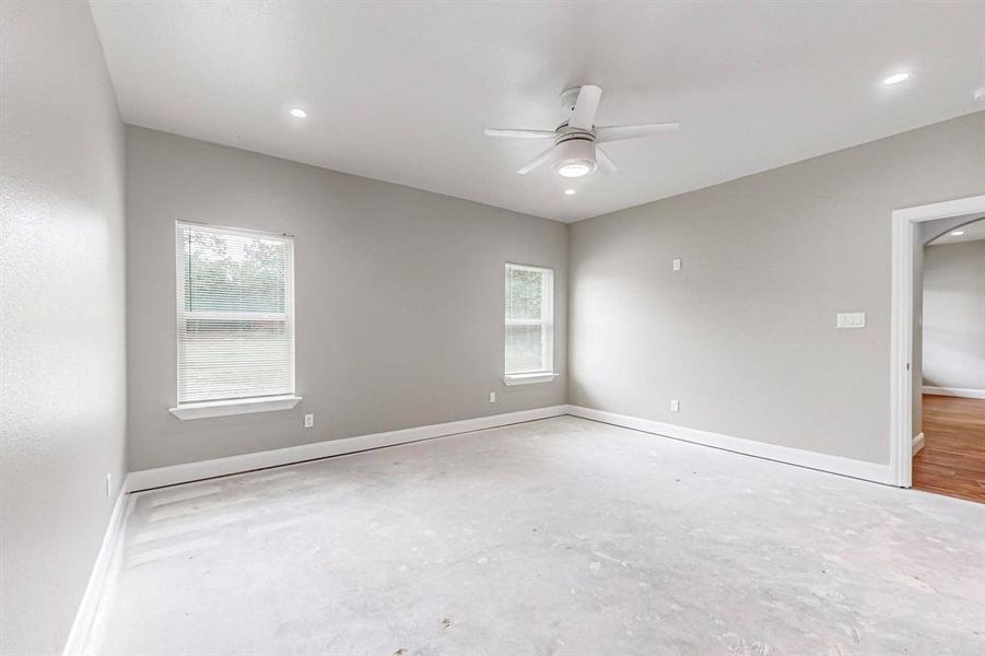 Empty room featuring ceiling fan and hardwood / wood-style flooring