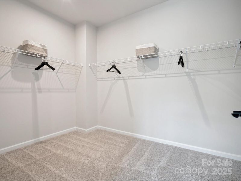 Primary Walk-In Closet.  *Model Photos | Actual Finishes, Structural Selections, and Orientation May Vary.