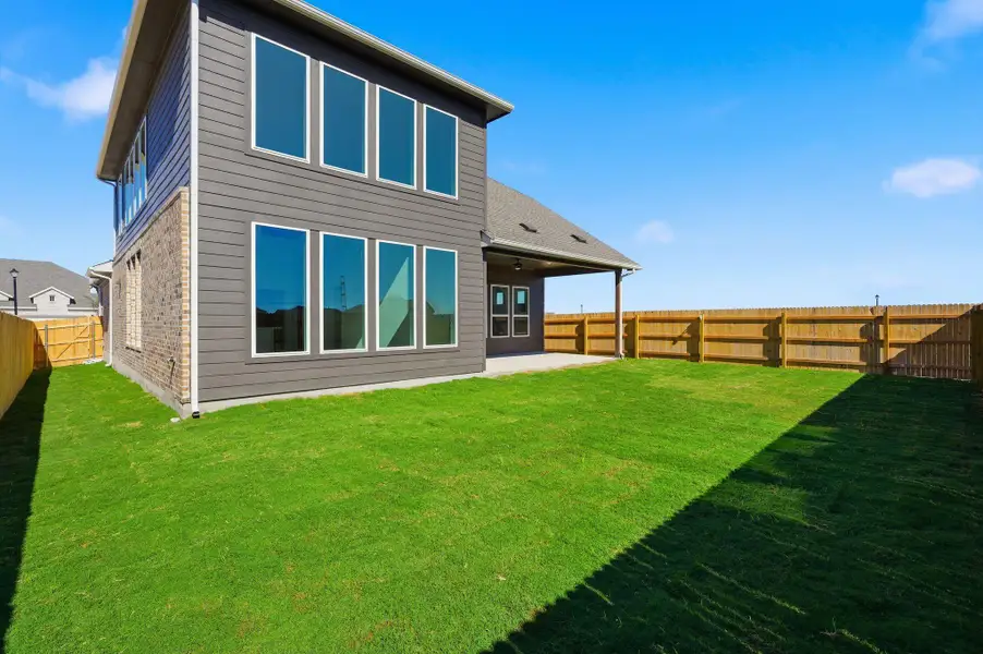 Rear view of property with a patio area, a fenced backyard, and a ceiling fan