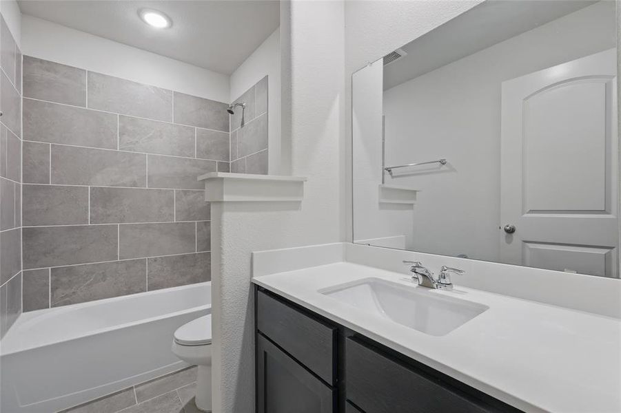 Bathroom featuring vanity and bathtub / shower combination