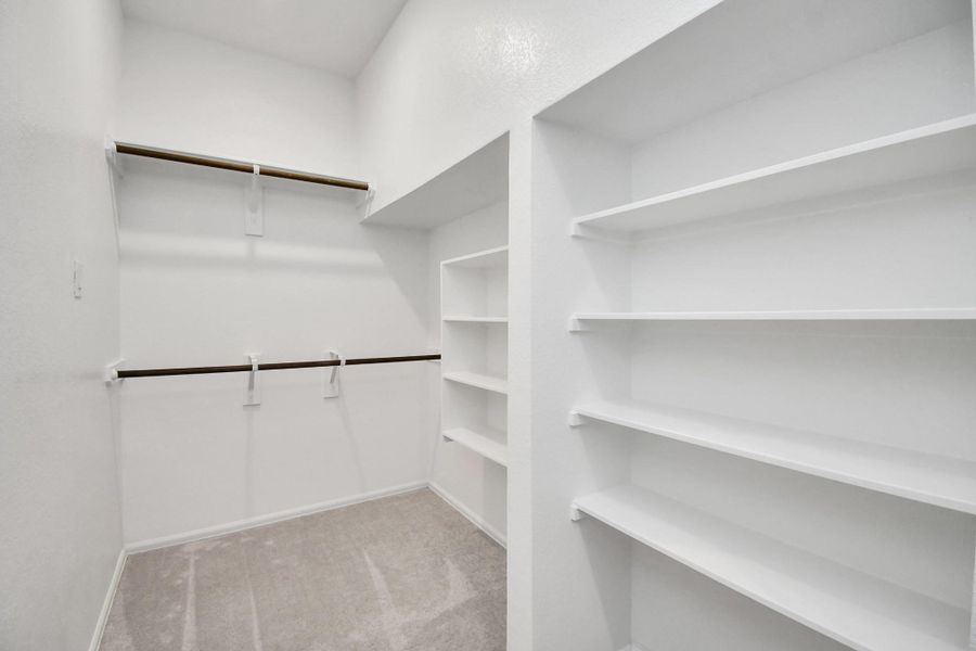Spacious and organized, this closet offers abundant shelving and hanging space.