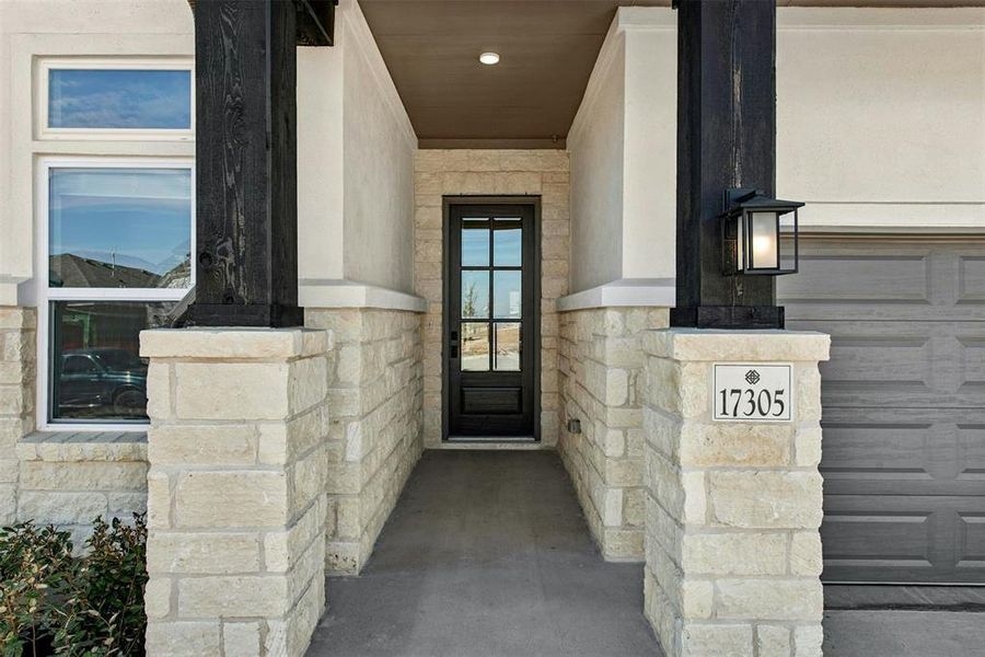 Stone veneer facade with stucco accents