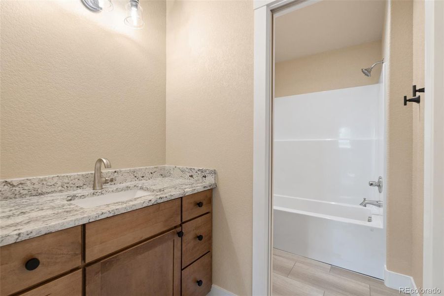 Full guest bathroom on upper level (mirror to be installed prior to closing) Full guest bathroom on upper level (mirror to be installed prior to closing)