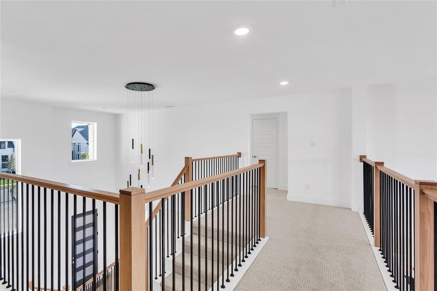 Hall featuring an upstairs landing, recessed lighting, and carpet