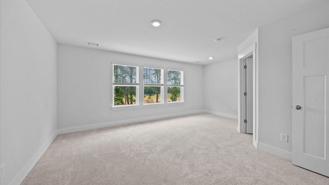 Expansive primary suite with large windows in two story townhome at Ransdell Pointe by DRB Homes in Spartanburg, SC