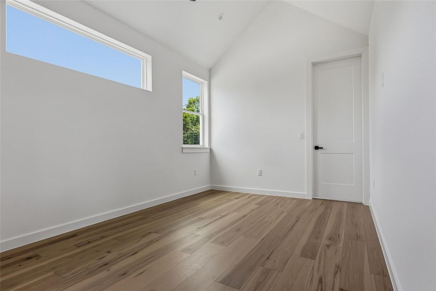 Upstairs secondary bedroom, engineered wood flooring.