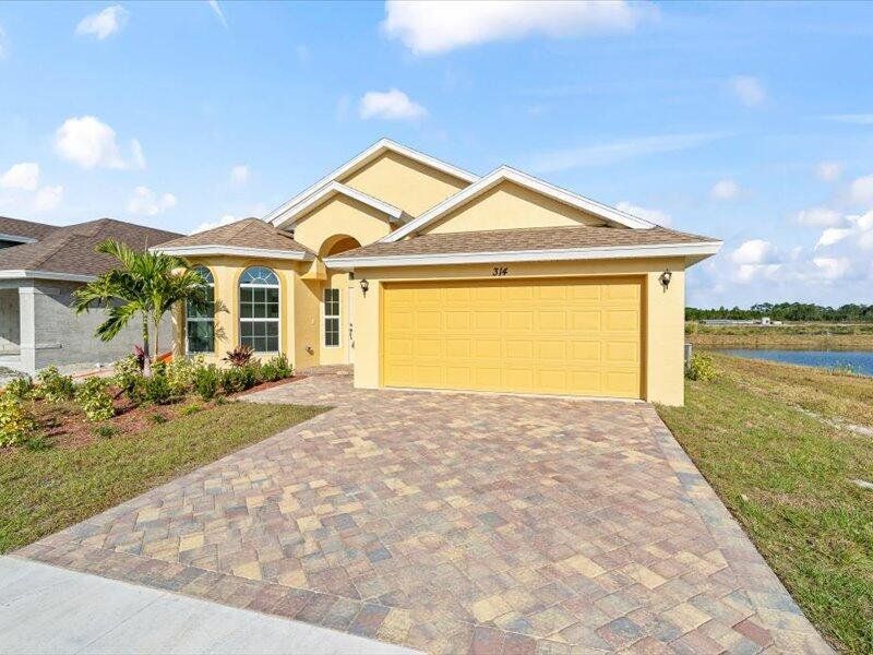 Front exterior of a new home in , Fort Pierce, FL, highlighting curb appeal (Image 2).