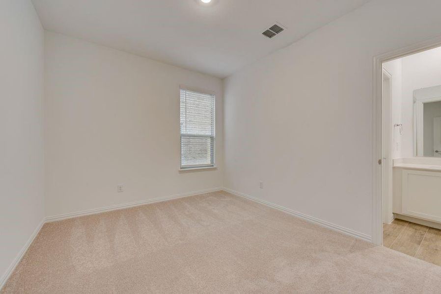 Unfurnished room featuring light carpet